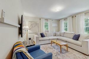 a living room with a couch and a table at 10-Minute Walk to the Beach in Cumberland Foreside