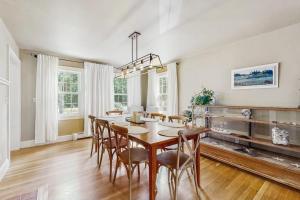 a dining room with a wooden table and chairs at 10-Minute Walk to the Beach in Cumberland Foreside