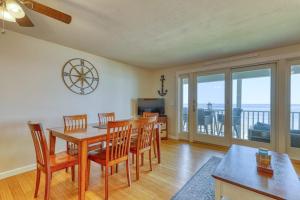 a dining room with a table and chairs and a television at Scouten Beachfront in Old Orchard Beach