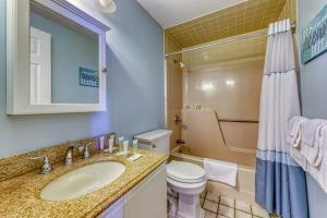 a bathroom with a sink and a toilet at Scouten Beachfront in Old Orchard Beach +40 photos