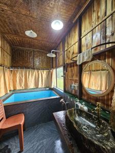 a bathroom with a bath tub and a sink at Tràng An Gold in Xuân Sơn