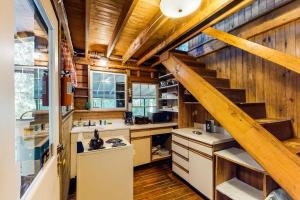 a kitchen with wooden walls and a staircase in a house at Garden Island's Cedar in Charlotte +52 photos