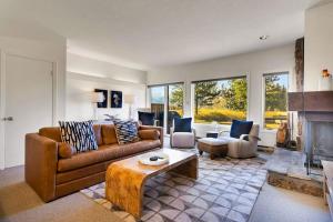 a living room with a couch and a fireplace at Glacier D in Jackson