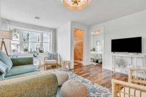 a living room with a couch and a tv at Salt & Petal in Old Orchard Beach