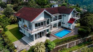 an aerial view of a house with a swimming pool at Wisma Nirwana Tretes near Cimory Prigen in Prigen