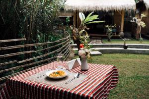 a table with a plate of food on top of it at Pondok Sapta Sallaca in Selat