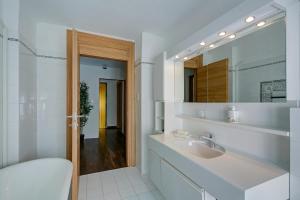 a bathroom with a sink and a mirror at Maroggia Apartments in Maroggia +38 photos