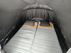 two beds in the back of a tent at Thursina Camping Ground in Paragajen
