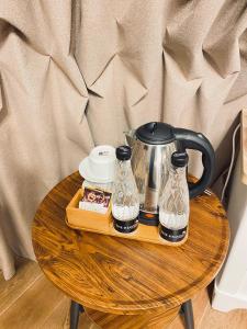 a tray with a tea kettle and glasses on a table at The Heaven Royal Glamp in Bedakah