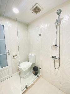 a white bathroom with a shower and a toilet at The Heaven Royal Glamp in Bedakah