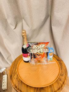 a bottle of champagne and glasses on a wooden tray at The Heaven Royal Glamp in Bedakah +3 photos