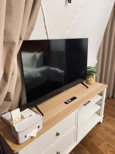 a flat screen tv sitting on top of a dresser at The Heaven Royal Glamp in Bedakah