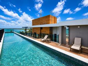 a house with a swimming pool on top of it at Beachfront flat at Porto de Galinhas beach, close to the natural pools. in Porto De Galinhas