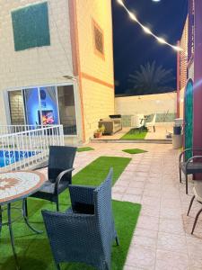 a patio with chairs and a table and a table and chairs at استراحة الرايس in Rayyis +4 photos
