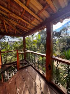 a balcony of a house with a view of the forest at Chalé Retiro Real in Ouro Preto +7 photos