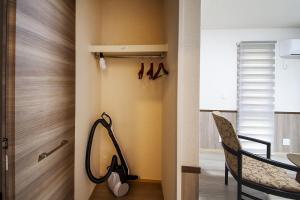 a room with a closet with a treadmill and a chair at 萩別邸 シーサイド1 HAGI Bettei SEASIDE1 in Hagi