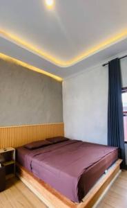 a bedroom with a purple bed in a room at villa house luxury in Cianjur