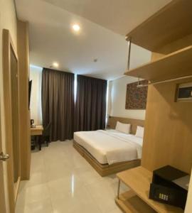 a hotel room with a bed and a desk at villa house luxury in Cianjur