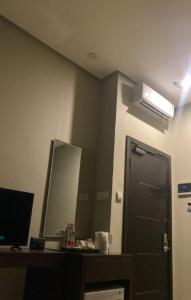 a bathroom with a mirror and a black door at villa house luxury in Cianjur