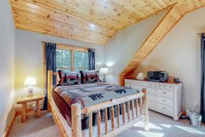 a bedroom with a bed and a wooden ceiling at Pinecone Lodge in Newry