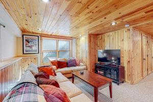 a living room with a couch and a tv at Pinecone Lodge in Newry