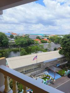 a view from a balcony of a building with a river at Metro Residence in Surin