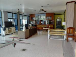 a living room with a couch and a table at Metro Residence in Surin