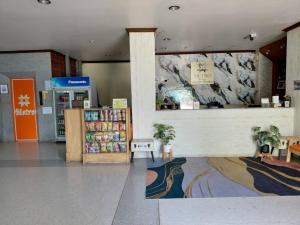 a store lobby with a counter in a store at Metro Residence in Surin