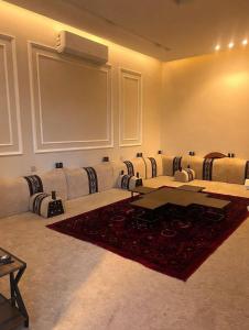 a large room with a table and chairs at Over lock in Buraydah