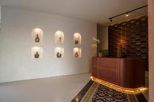 a room with a table and some vases on the wall at Soocha Villas in Yogyakarta