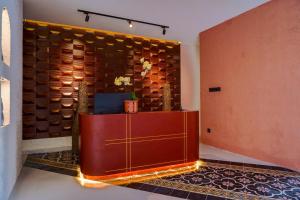 a lobby with a reception desk and a wall of wood at Soocha Villas in Yogyakarta +24 photos