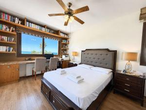 a bedroom with a bed and a desk and a window at Emerald Seafront Residence in Ayia Napa +29 photos