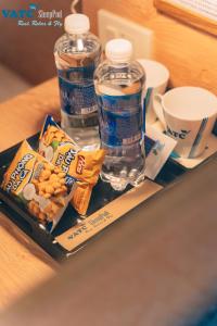 a tray with snacks and water bottles on a table at VATC Sleep Pod Terminal 1 in Noi Bai