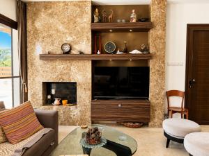 a living room with a couch and a fireplace at Emerald Seafront Residence in Ayia Napa