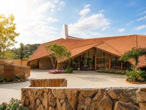 a building with a red roof and a stone wall at Camly the Boutique in Da Lat