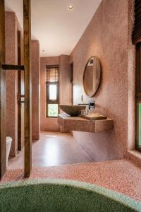 a bathroom with a sink and a mirror at Camly the Boutique in Da Lat