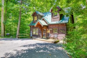 a wooden house with a blue roof in the forest at Naughty Pines in Pigeon Forge