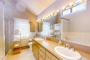 a bathroom with two sinks and a large mirror at Barefoot Bliss in Kennebunk +50 photos
