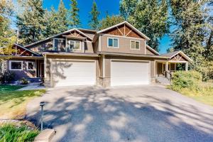 a house with two garage doors on a driveway at Cedar Point Hideaway in Columbia Falls