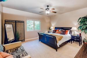 a bedroom with a bed and a ceiling fan at Cedar Point Hideaway in Columbia Falls