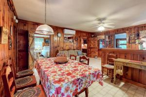 a dining room with a table and a kitchen at Otis Cottages in York