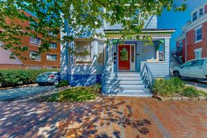 a blue house with a red door on a street at Cumberland Casa - B in Portland