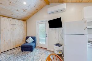 a living room with a refrigerator and a chair at Shorelands, Unit 44-3 in Kennebunk