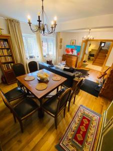 a living room with a table and chairs and a couch at Bohemian Chalet in Buşteni
