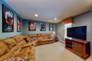 a large living room with a large couch and a flat screen tv at Moose Lodge in Newry