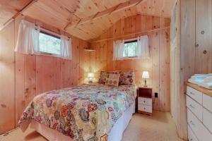 a bedroom with a bed in a wooden cabin at Brandy Shores in Naples