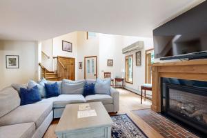 a living room with a couch and a fireplace at Thompson Lake Estate in Poland