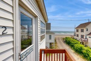 a window on a house with a view of the ocean at Seaglass Cottage in York
