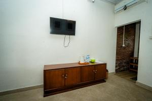 a living room with a tv on a wall at Wisma Nirwana Tretes near Cimory Prigen in Prigen