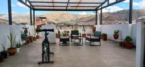 a room with a bike and chairs and mountains at Apartamento cerca de todo en Cusco in Cusco